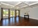 Large, bright room with hardwood floors, coffered ceilings, and elegant windows at 3195 Wills Mill Rd, Cumming, GA 30041