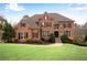 Stately brick home with manicured lawn and lush landscaping exudes curb appeal at 3195 Wills Mill Rd, Cumming, GA 30041