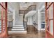 Grand foyer with hardwood floors, a curved staircase, and elegant chandelier at 3195 Ne Wills Mill Ne Rd, Cumming, GA 30041