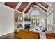 Cozy living room featuring a stone fireplace, hardwood floors, and large windows at 3195 Wills Mill Rd, Cumming, GA 30041