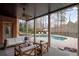 Covered patio with outdoor seating area overlooking the pool and beautifully landscaped backyard at 3195 Wills Mill Rd, Cumming, GA 30041