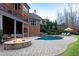 Backyard with a beautiful pool, cozy firepit, and lounge chairs at 3195 Wills Mill Rd, Cumming, GA 30041