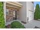 Townhome showcasing a stone accent wall, door, and one-car garage at 556 Oakside Pl, Acworth, GA 30102