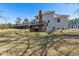 A sprawling backyard with a multi-level deck, offering ample space for outdoor entertaining and relaxation at 684 Old Cumming Rd, Sugar Hill, GA 30518