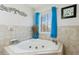 Bright bathroom featuring a corner tub at 684 Old Cumming Rd, Sugar Hill, GA 30518