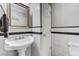 Bathroom features black and white tiling and decorative trim at 684 Old Cumming Rd, Sugar Hill, GA 30518