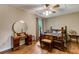 Cozy bedroom featuring hardwood floors, vintage furniture and a charming bed frame, bathed in soft natural light at 684 Old Cumming Rd, Sugar Hill, GA 30518