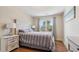 Bedroom features hardwood flooring with a large window and dresser with a decor lamps at 684 Old Cumming Rd, Sugar Hill, GA 30518