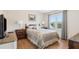 Comfortable bedroom with a large window, wood floors, and neutral decor at 684 Old Cumming Rd, Sugar Hill, GA 30518