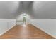 Spacious bonus room under the eaves with wood-look flooring and light from windows at 684 Old Cumming Rd, Sugar Hill, GA 30518