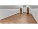 Large bonus room with wood floors, white trim, and built-in storage shelves offering versatile space at 684 Old Cumming Rd, Sugar Hill, GA 30518