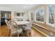 This dining room showcases a wooden floor, windows with a seat, and a stylish table set at 684 Old Cumming Rd, Sugar Hill, GA 30518