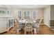 Bright dining room featuring a white table with seating for six and a built-in buffet at 684 Old Cumming Rd, Sugar Hill, GA 30518