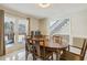 Bright dining area with a wooden table, seating for six, and large windows to view the front porch at 684 Old Cumming Rd, Sugar Hill, GA 30518