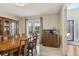 Light-filled dining area with a wooden table, seating for six, and a view to the home entry at 684 Old Cumming Rd, Sugar Hill, GA 30518