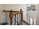 Bright entryway with decorative staircase railing, chandelier and transom window above the front door at 684 Old Cumming Rd, Sugar Hill, GA 30518