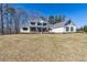 Two story white house with a covered front porch and large front yard at 684 Old Cumming Rd, Sugar Hill, GA 30518