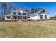 Beautifully landscaped two-story white home with a covered front porch and well-maintained lawn at 684 Old Cumming Rd, Sugar Hill, GA 30518