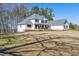 Well-kept two-story home featuring a manicured front lawn and stone accents at 684 Old Cumming Rd, Sugar Hill, GA 30518