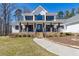 Charming two-story home featuring a welcoming front porch, stone accents, and manicured landscaping at 684 Old Cumming Rd, Sugar Hill, GA 30518