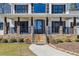 Inviting two-story home with a covered porch, stone detailing, and well-manicured walkway at 684 Old Cumming Rd, Sugar Hill, GA 30518