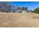 Spacious front yard leading up to a two-story home with grey roof at 684 Old Cumming Rd, Sugar Hill, GA 30518