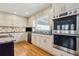 Bright kitchen featuring stainless steel appliances, modern cabinets and a mosaic tile backsplash at 684 Old Cumming Rd, Sugar Hill, GA 30518