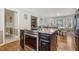 Kitchen with stainless steel appliances and breakfast bar with granite countertops at 684 Old Cumming Rd, Sugar Hill, GA 30518