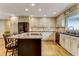 Open kitchen with an island and seating, stainless steel appliances and modern cabinets at 684 Old Cumming Rd, Sugar Hill, GA 30518
