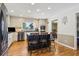 Modern kitchen with stainless steel appliances, wooden floors, and a center island with seating at 684 Old Cumming Rd, Sugar Hill, GA 30518