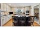 Modern kitchen featuring an island with seating, granite countertops, and stainless steel appliances at 684 Old Cumming Rd, Sugar Hill, GA 30518