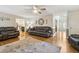 Spacious living room with hardwood floors, comfortable seating, and natural light at 684 Old Cumming Rd, Sugar Hill, GA 30518