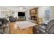 Spacious living area with stone fireplace, hardwood floors, and comfortable seating at 684 Old Cumming Rd, Sugar Hill, GA 30518