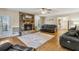 Living room with a stone fireplace, hardwood floors, and a view of the outdoor space at 684 Old Cumming Rd, Sugar Hill, GA 30518