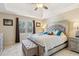 Inviting primary bedroom with a tray ceiling, tiled floors, and large windows at 684 Old Cumming Rd, Sugar Hill, GA 30518
