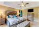 Stylish main bedroom with a tray ceiling, tiled floors, and modern furnishings at 684 Old Cumming Rd, Sugar Hill, GA 30518
