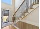 Grand foyer with staircase featuring iron spindles and a view of the front entrance at 684 Old Cumming Rd, Sugar Hill, GA 30518