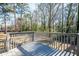 Spacious back deck overlooking a lush, wooded backyard with mature trees, offering privacy and a tranquil setting at 2411 Fair Ln, Decatur, GA 30032