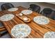 Dining room featuring a wooden table with decoratively placed dinnerware and woven-back chairs at 2411 Fair Ln, Decatur, GA 30032