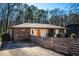 Charming home exterior with an inviting orange front door, wood and white facade, complemented by a stylish fence and yard at 2411 Fair Ln, Decatur, GA 30032