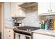 Close-up of modern kitchen with marble countertops, stainless steel appliances, and stylish backsplash at 2411 Fair Ln, Decatur, GA 30032