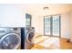 Sun-filled laundry room with a washer and dryer set and double doors to the outside at 2411 Fair Ln, Decatur, GA 30032