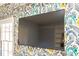 Bright living room with vibrant wallpaper and a large screen television at 2411 Fair Ln, Decatur, GA 30032