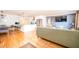 Bright open-concept living room showcasing hardwood floors, a dining area, a kitchen bar, and a comfortable lounge at 2411 Fair Ln, Decatur, GA 30032