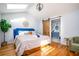 Spacious main bedroom with hardwood floors, a skylight and en-suite bathroom at 2411 Fair Ln, Decatur, GA 30032