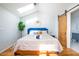 Bright main bedroom with a skylight, hardwood floors and a sliding door to the bathroom at 2411 Fair Ln, Decatur, GA 30032