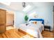 Bright and airy main bedroom featuring hardwood floors, a comfortable bed, and plenty of natural light from a skylight at 2411 Fair Ln, Decatur, GA 30032