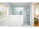 Spacious shower with glass door and sleek white subway tile design at 2411 Fair Ln, Decatur, GA 30032