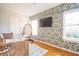 Sitting room with tropical wallpaper, modern furniture, and hardwood floors at 2411 Fair Lane Ln, Decatur, GA 30032