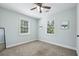 A simple and well-lit bedroom featuring carpeted floors and two windows at 3261 Lowndes St, Atlanta, GA 30337